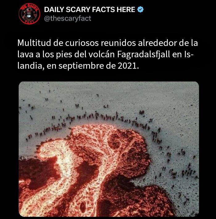Multitud observando la lava ardiente del volcán Fagradalsfjall en Islandia, dato terrorífico impactante en la oscuridad.
