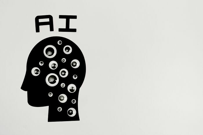 Ilustración de cabeza con ojos y siglas de IA, simbolizando tecnologías que desplazan a industrias por colapsar