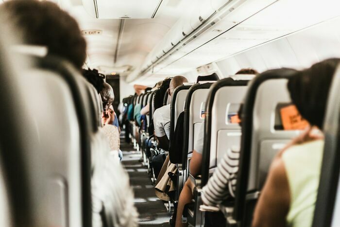 Pasajeros en asientos interiores de avión en vuelo